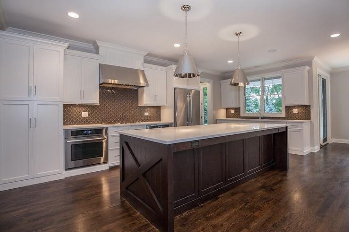 brown-arbesque-tile-backsplash-cooktop-between-ovens